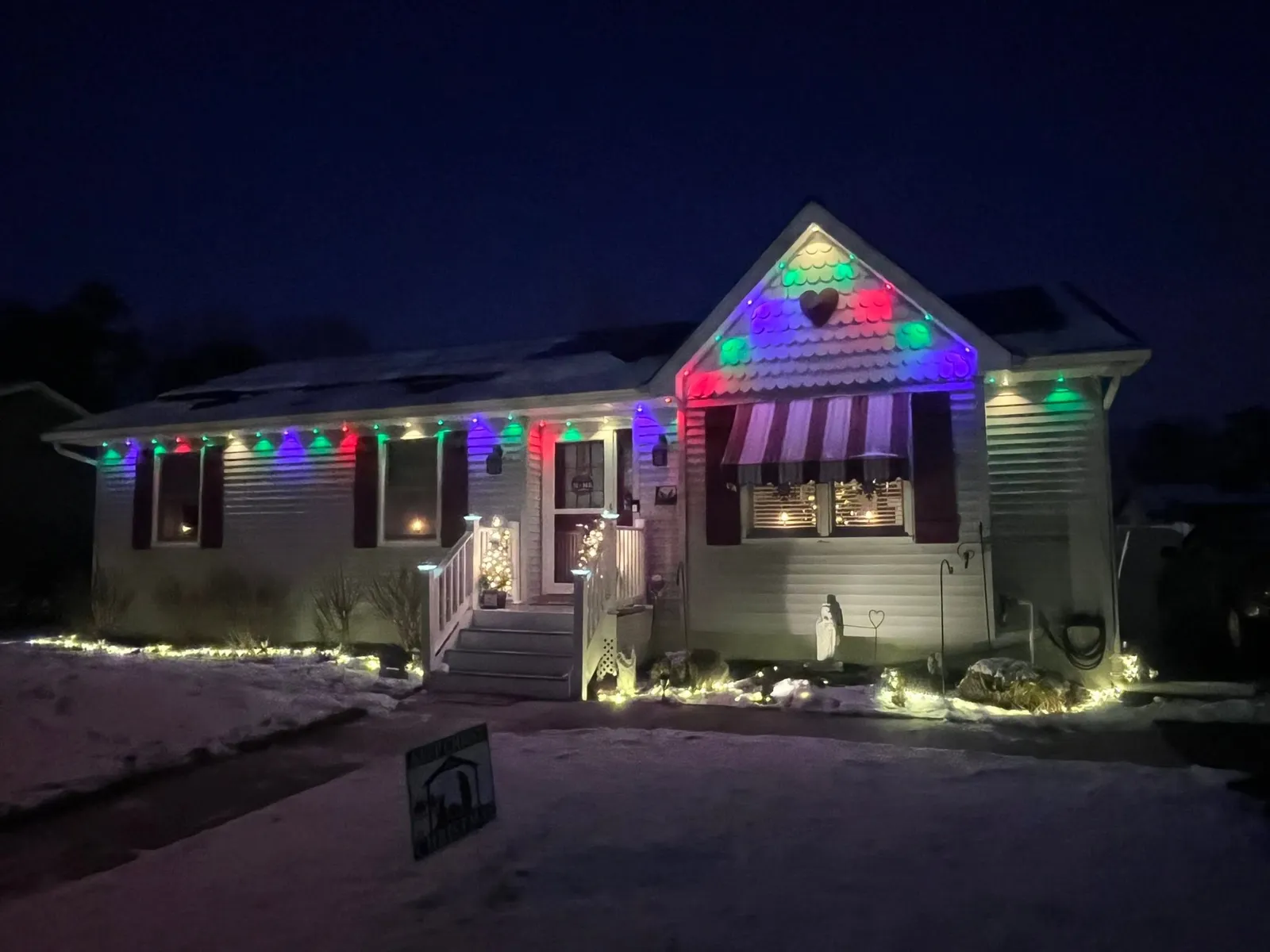 Ranch home with multicolor permanent lighting zones in red, green, and purple