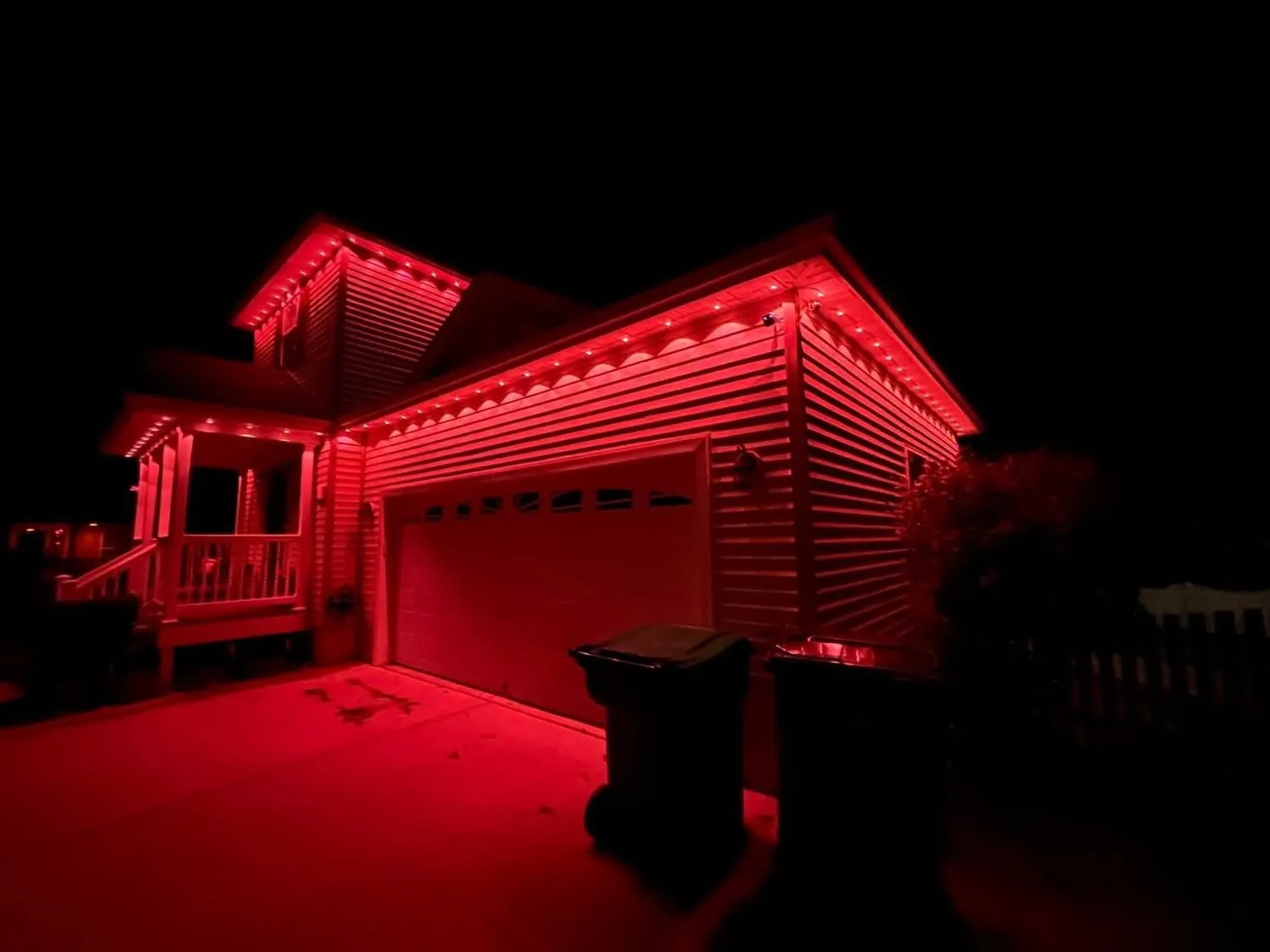 Garage and rooflines washed in deep red permanent lighting